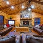 Great room with TV and fIreplace along with dininig