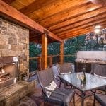 Outdoor deck with fireplace and dining