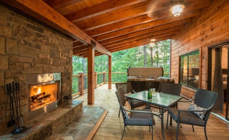 Outdoor deck with fireplace and dining