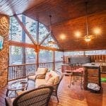 Mountain Melody back deck with fireplace, TV, hot tub, seating, and bar area.