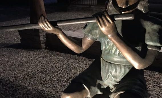 statue girl playing flute
