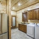 utility room with extra fridge and washer and dryer