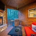harmony in the pines outside seating area with fireplace and tv