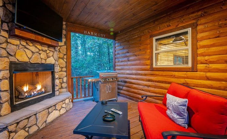 harmony in the pines outside seating area with fireplace and tv