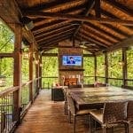 Large outdoor deck with seating and TV