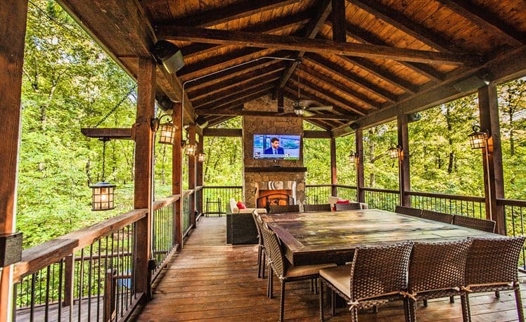 Large outdoor deck with seating and TV