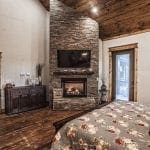 Master bedroom with fireplace and TV