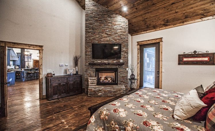 Master bedroom with fireplace and TV