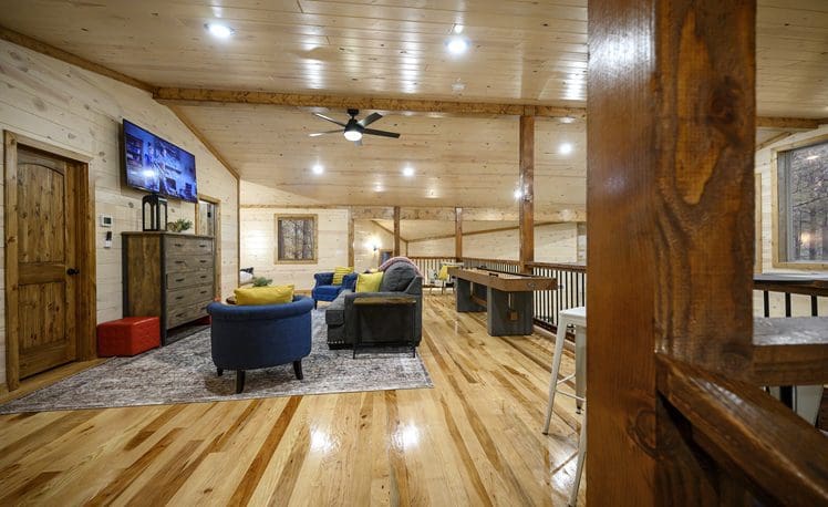 Upstair loft with seating and TV and Shuffle Board