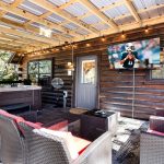 Back deck with hot tub and seating along with TV