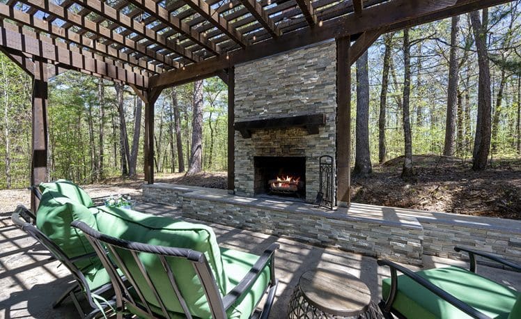 Outside deck with fireplace and furniture