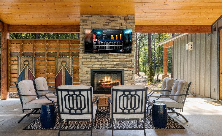Outdoor seating with fireplace and TV
