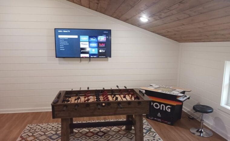 Game room with foosball table and TV