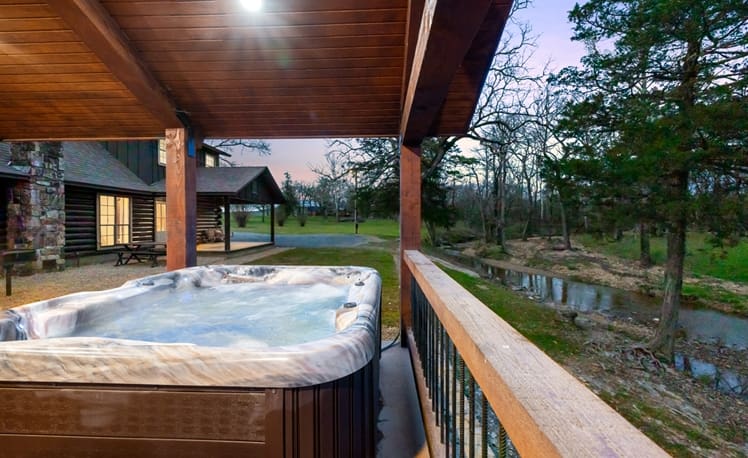 Covered hot tub overlooking creek