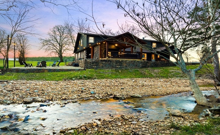 view of cabin across a creek