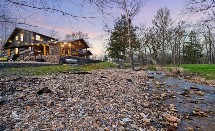 view of cabin across a creek
