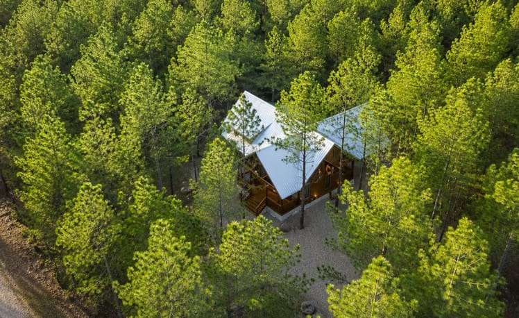 Aerial view of just chillin showing trees surrounding cabin