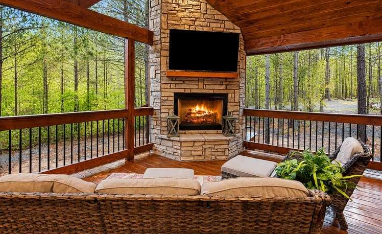 Image of furniture outdoor TV and fireplace on back deck at Just Chillin cabin