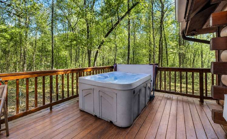 Hot tub on back deck forest cabin